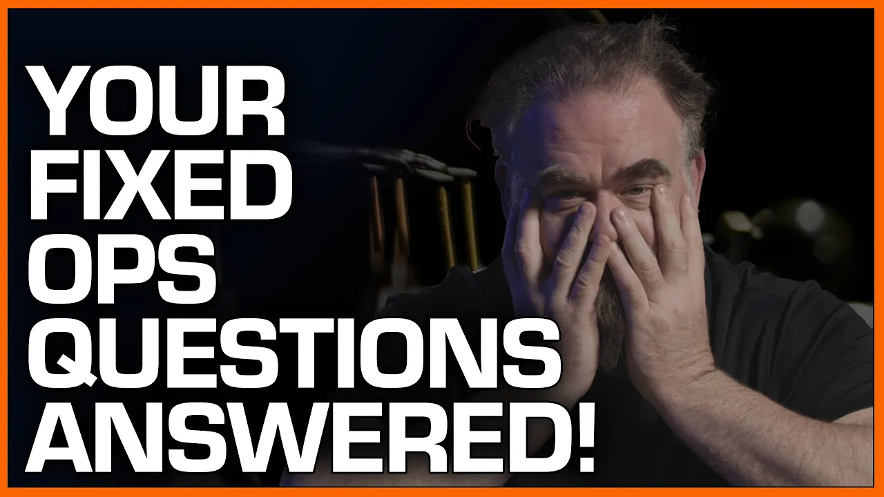 covering his face while discussing answers to fixed operations questions in an automotive industry video.