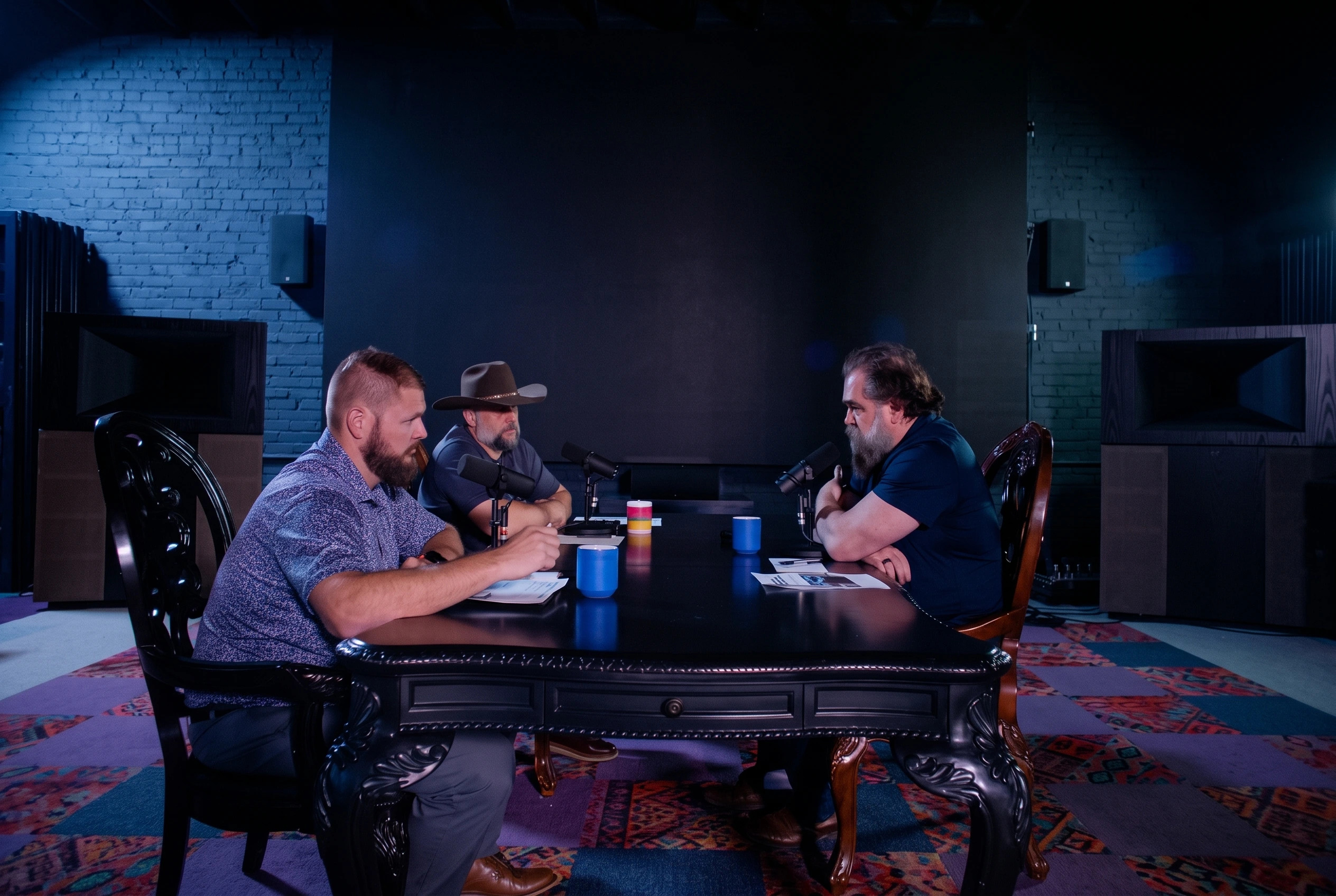 Three automotive industry professionals discussing service advisor coaching, dealership training, and customer service strategies during a podcast recording with microphones.
